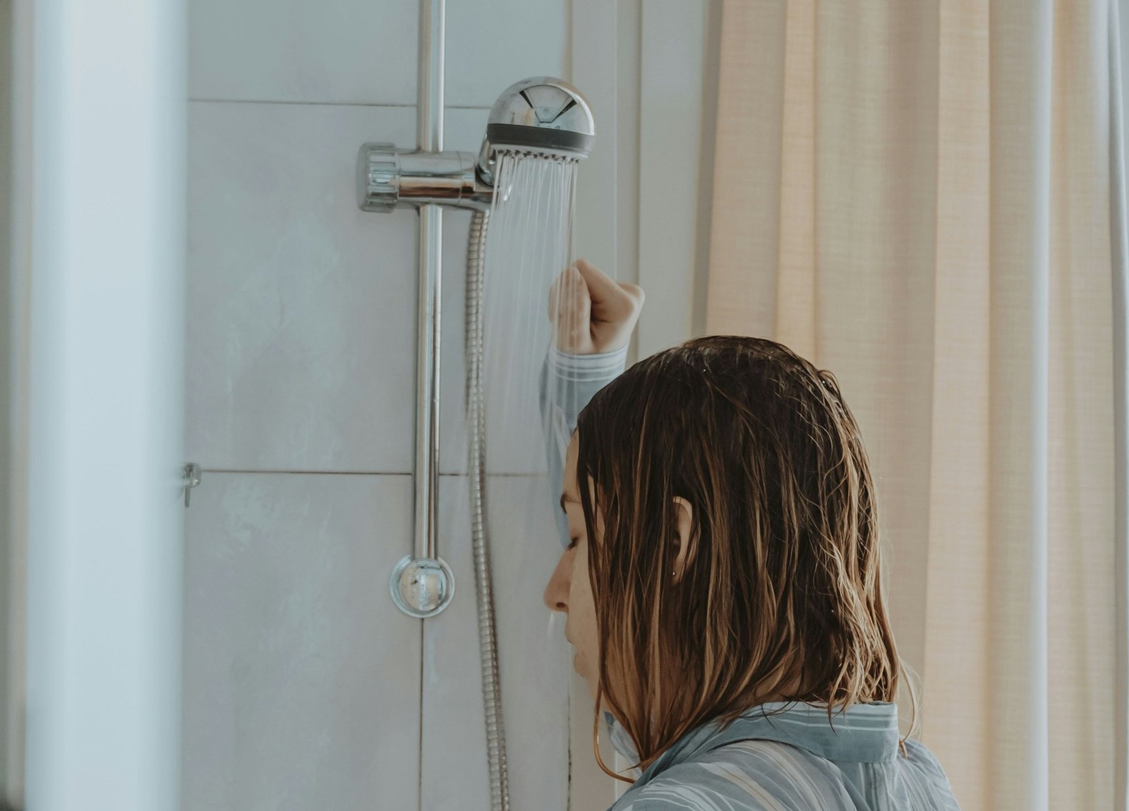 Duschkopf wird unter fließendem Wasser abgespült